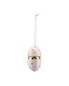 A white egg-shaped hanging ornament by Alessi, decorated with colorful studded dots, a gold band, and a chick's face peeking out.