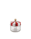 A decorative jar with a red and white striped lid by Alessi, featuring a gold finial and etched carousel horses on the clear glass base.