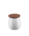 White glossy ceramic jar by Alessi with a brown wooden lid engraved with delicate botanical patterns.
