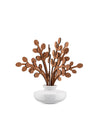 White ceramic diffuser by Alessi with intricate brown wooden leaf-shaped reeds.