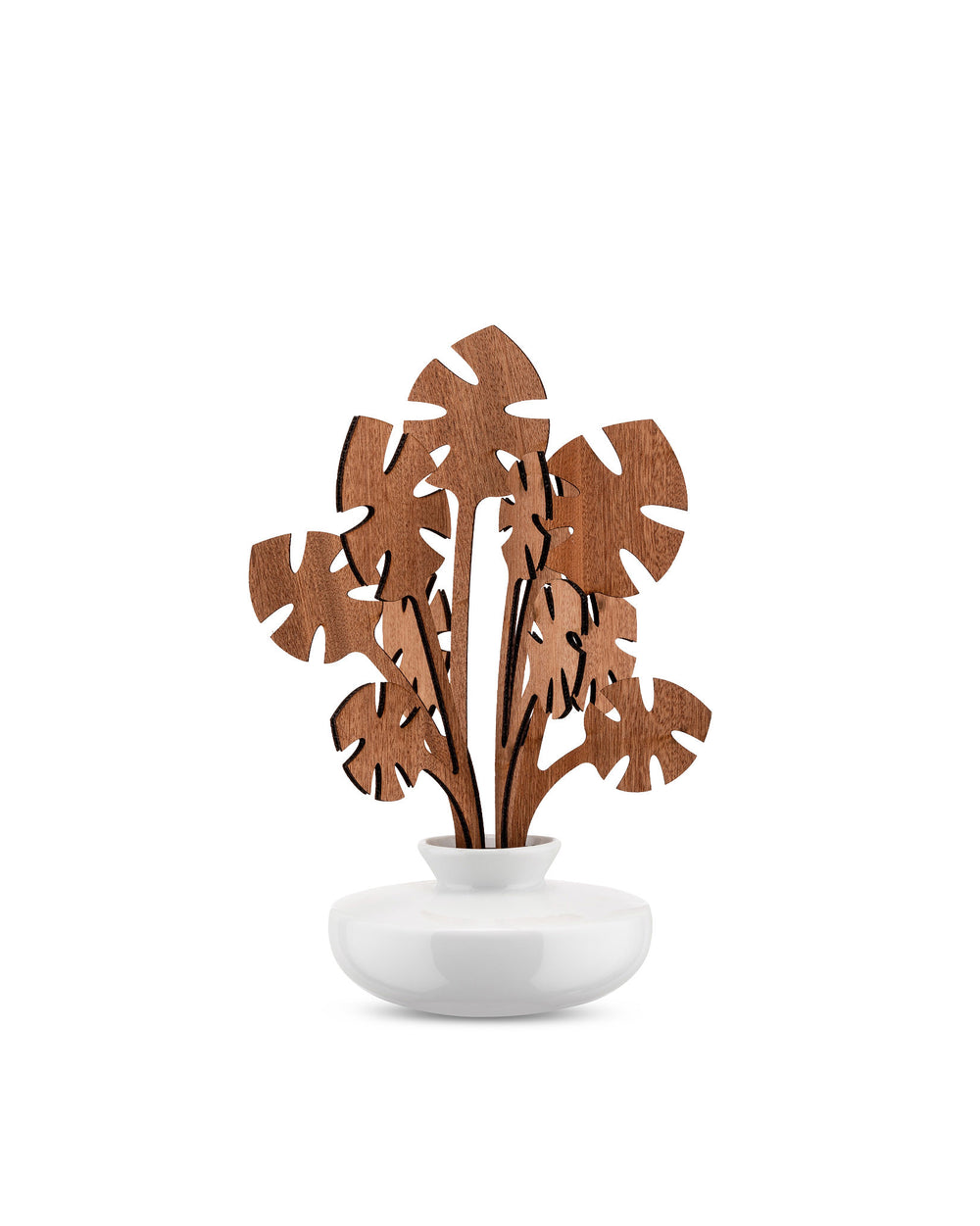 White ceramic diffuser with brown wooden monstera leaves by Alessi, standing upright on a white background.