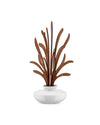 White ceramic room diffuser by Alessi with abstract brown wooden leaf-like reeds.