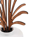 Brown wooden leaf-shaped diffuser by Alessi, with black holder in a white ceramic base.