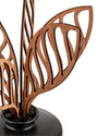 Laser-cut wooden air diffuser by Alessi with intricate leaf-like designs and a dark base, cropped view.