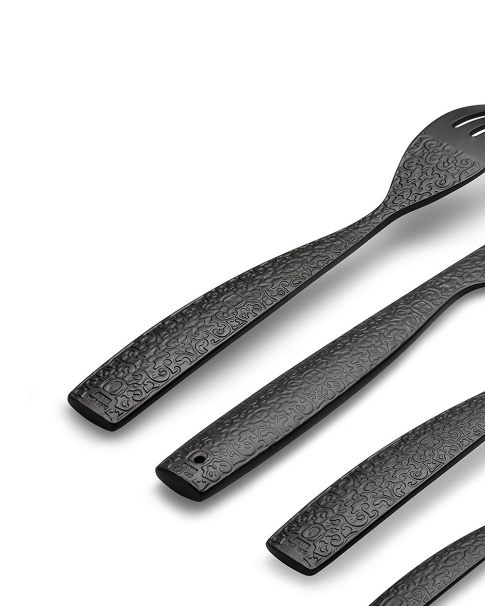 Black textured cutlery set by Alessi, with an intricate baroque pattern, angled on a white background.