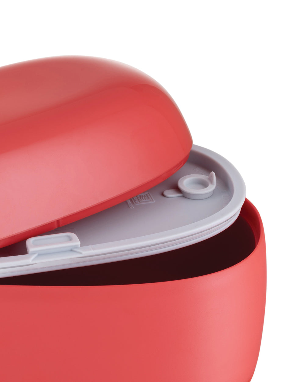 Red plastic food container by Alessi, partially open, showing a light gray interior and a small vent cap.
