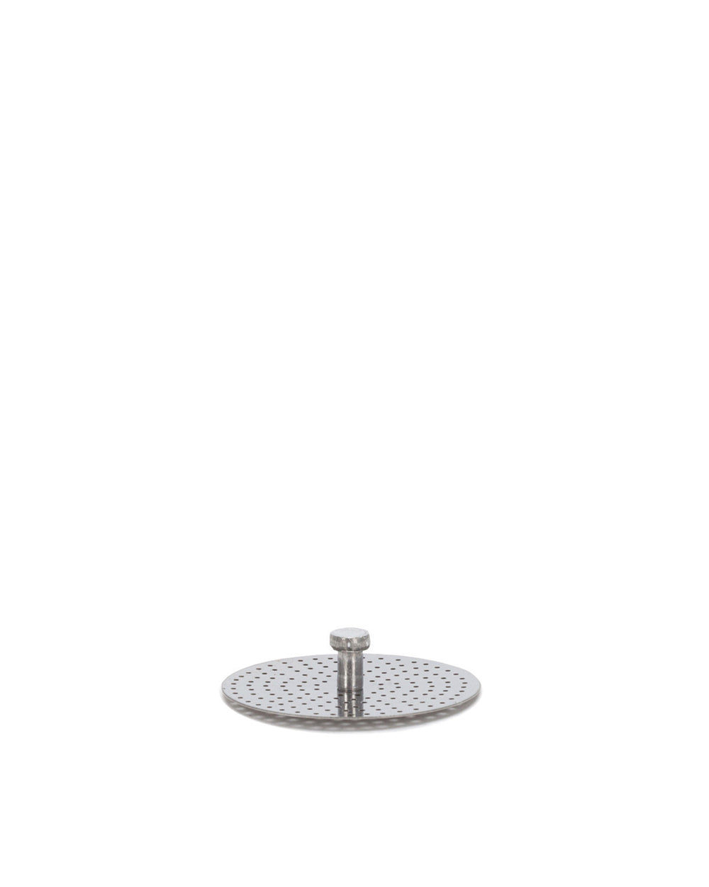 Round silver perforated metal spare part by Alessi, featuring a central bolt, subtly reflecting light on a white background.