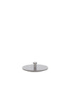 Perforated silver metal filter plate by Alessi, with a central cylindrical post, against a white background.