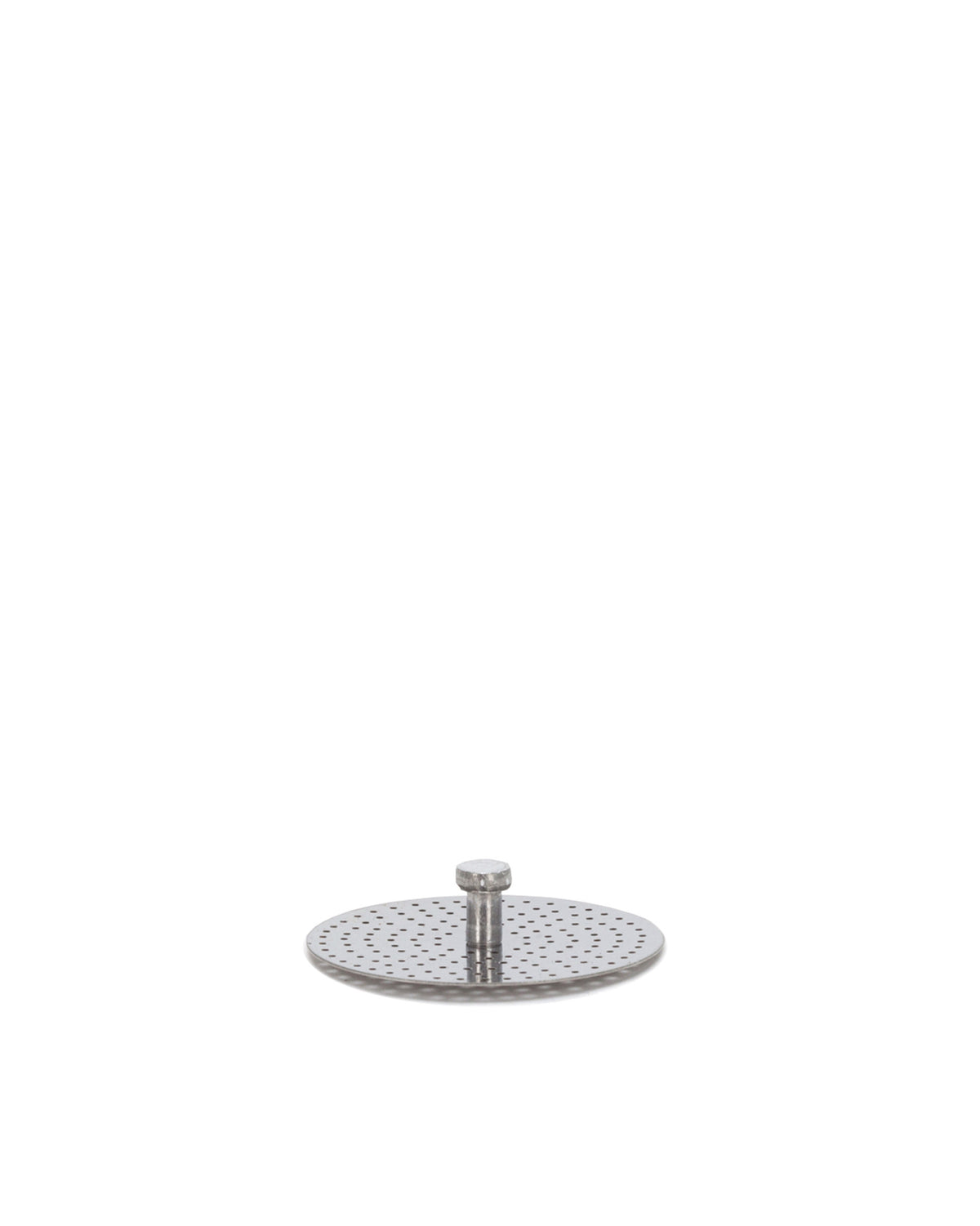 Perforated silver metal filter plate by Alessi, with a central cylindrical post, against a white background.