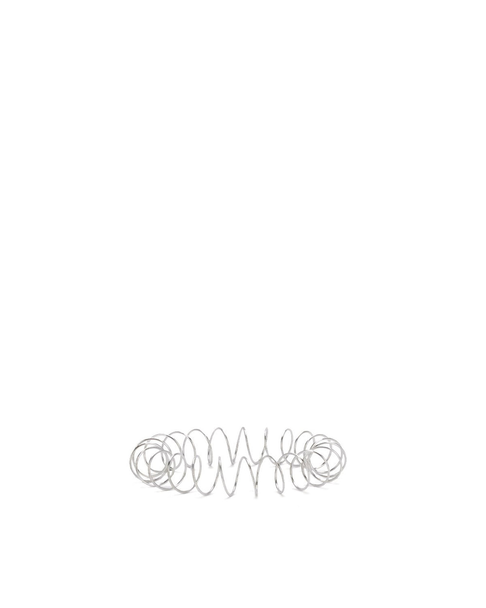 Silver metal spring spare part by Alessi, horizontally laid with loose coils in the center and tight coils at the ends.