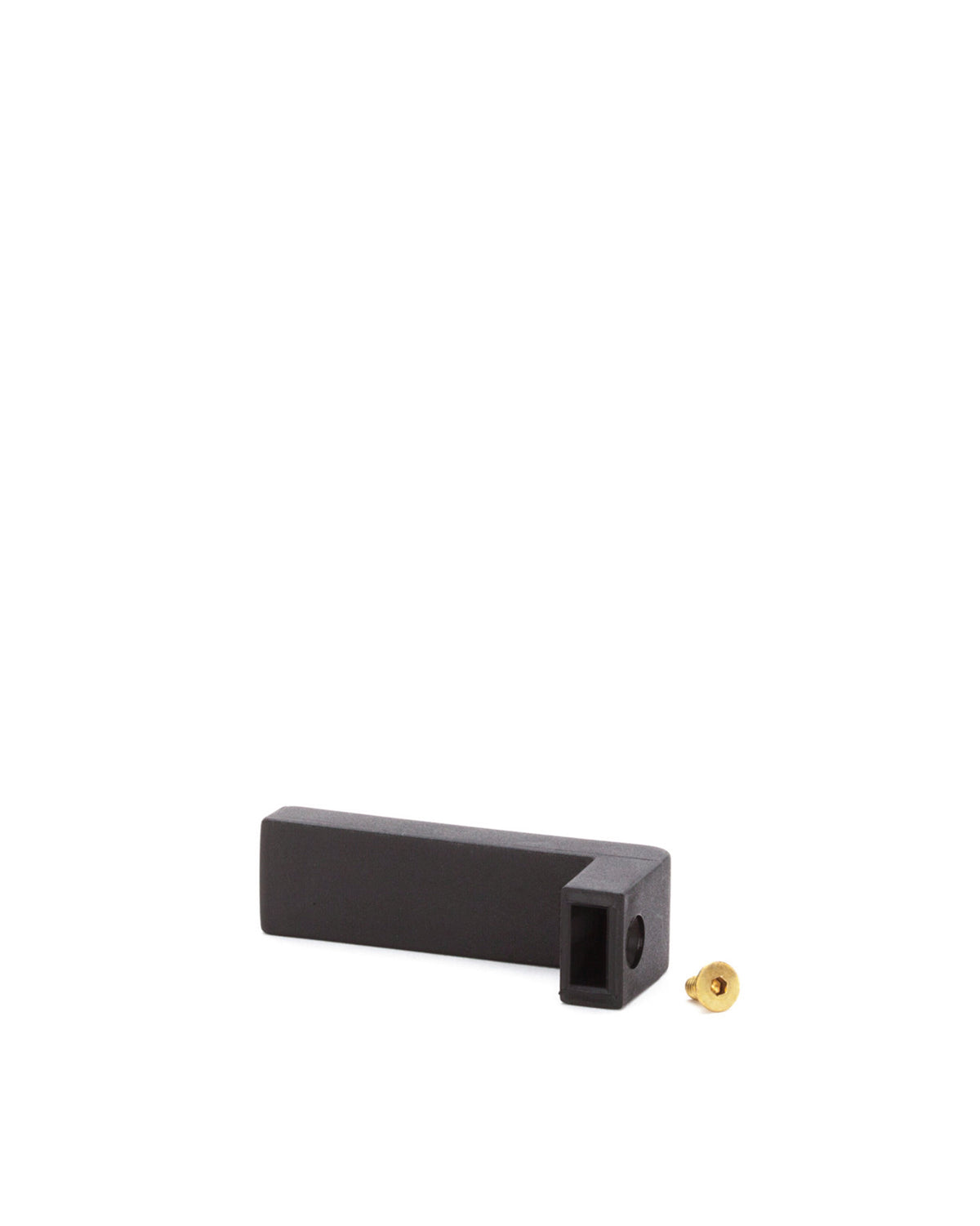 Black L-shaped spare part by Alessi, with a small brass screw beside it on a white background.
