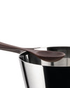 Sleek silver pasta pot by Alessi, with a brown spoon resting on its reflective rim.