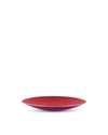 Shallow, perforated fruit bowl by Alessi with a red interior, magenta exterior, and silver rim.