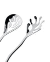 Mediterraneo serving plates by Alessi, featuring a shiny, sculptural slotted spoon and matching fork with flowing, abstract cutouts.