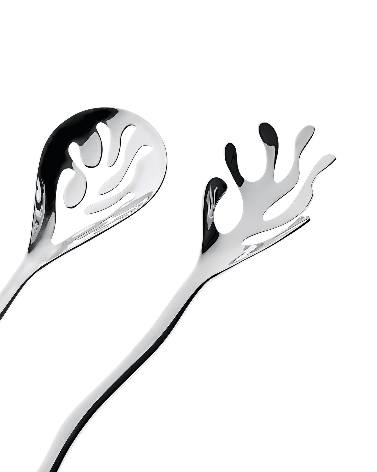 Mediterraneo serving plates by Alessi, featuring a shiny, sculptural slotted spoon and matching fork with flowing, abstract cutouts.